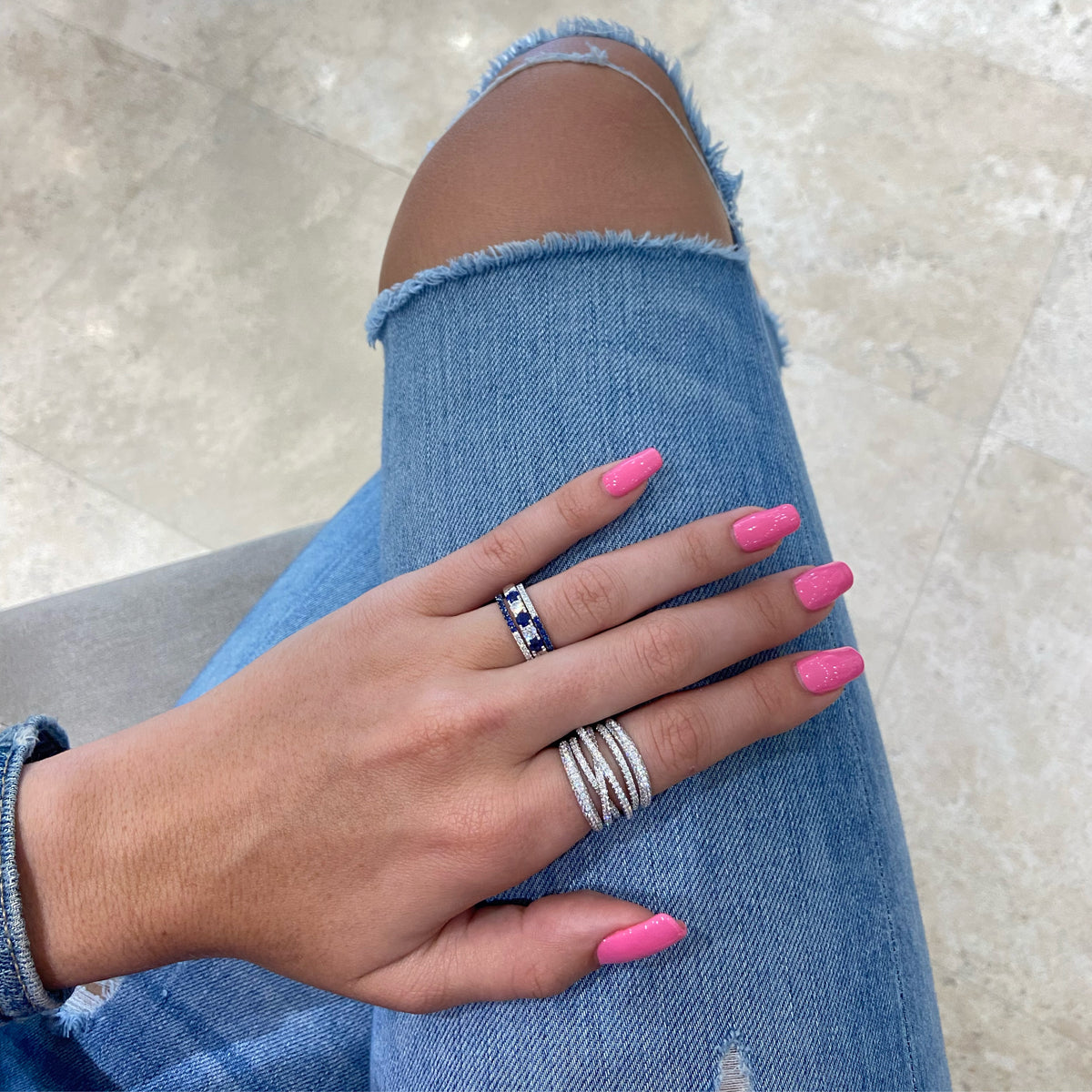 Female Model Wearing Diamond and Sapphire "Two-Tone" Stacking Ring - 14K gold weighing 1.27 grams - 20 round diamonds weighing 0.26 carats - 20 sapphires weighing 0.34 carats