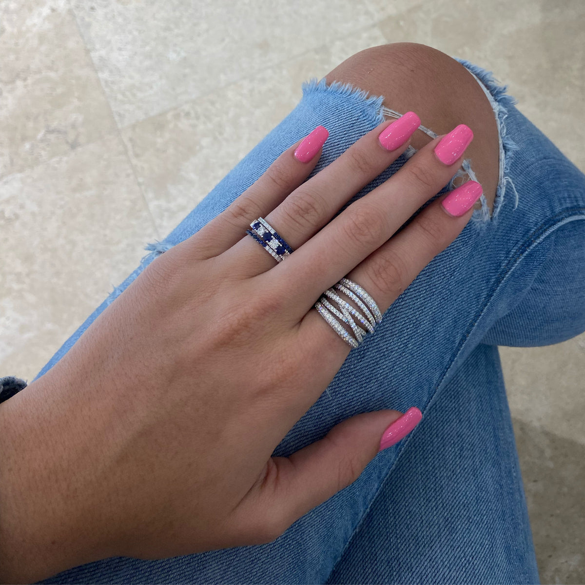 Female Model Wearing Diamond and Sapphire "Two-Tone" Stacking Ring - 14K gold weighing 1.27 grams - 20 round diamonds weighing 0.26 carats - 20 sapphires weighing 0.34 carats