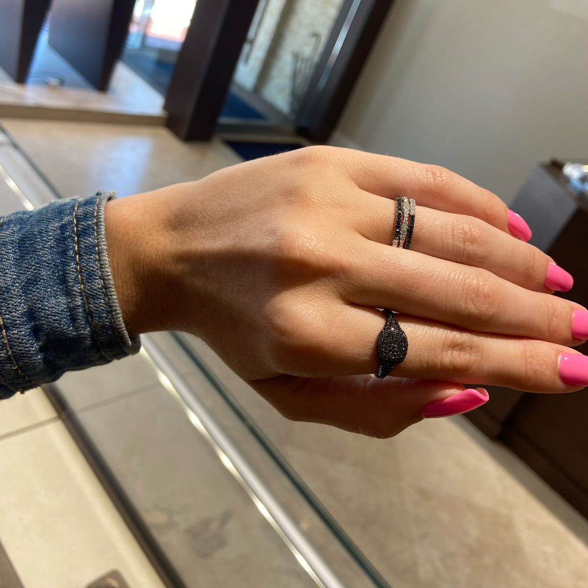 Female Model Wearing Black & 'White’ Diamond Eternity Band   -14K gold weighing 1.28 grams   -20 white round diamonds totaling 0.27 carats   -20 black diamond totaling 0.28 cts