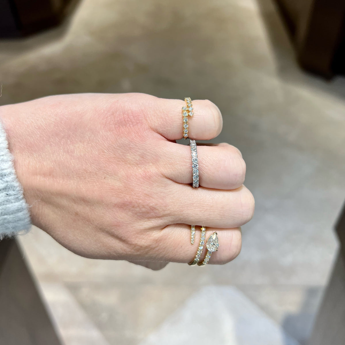 Female Model Wearing Prong-Set Diamond Wrap Ring - 14K gold weighing 1.59 grams - 13 round diamonds weighing 0.21 carats