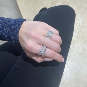 Female model wearing Baguette and Round Diamond Crossover Ring - 18K gold weighing 5.95 grams  - 30 round diamonds weighing 0.71 carats  - 21 slim baguettes weighing 1.20 carats