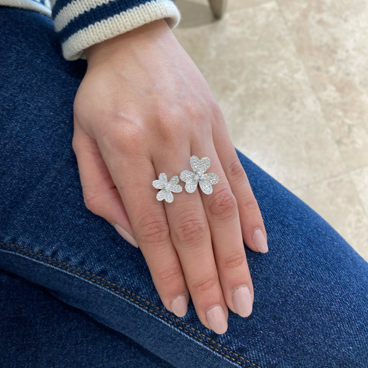 Female Model Wearing Diamond Double Flower Open Ring - 18K gold weighing 5.66 grams  - 124 round diamonds weighing 1.19 carats