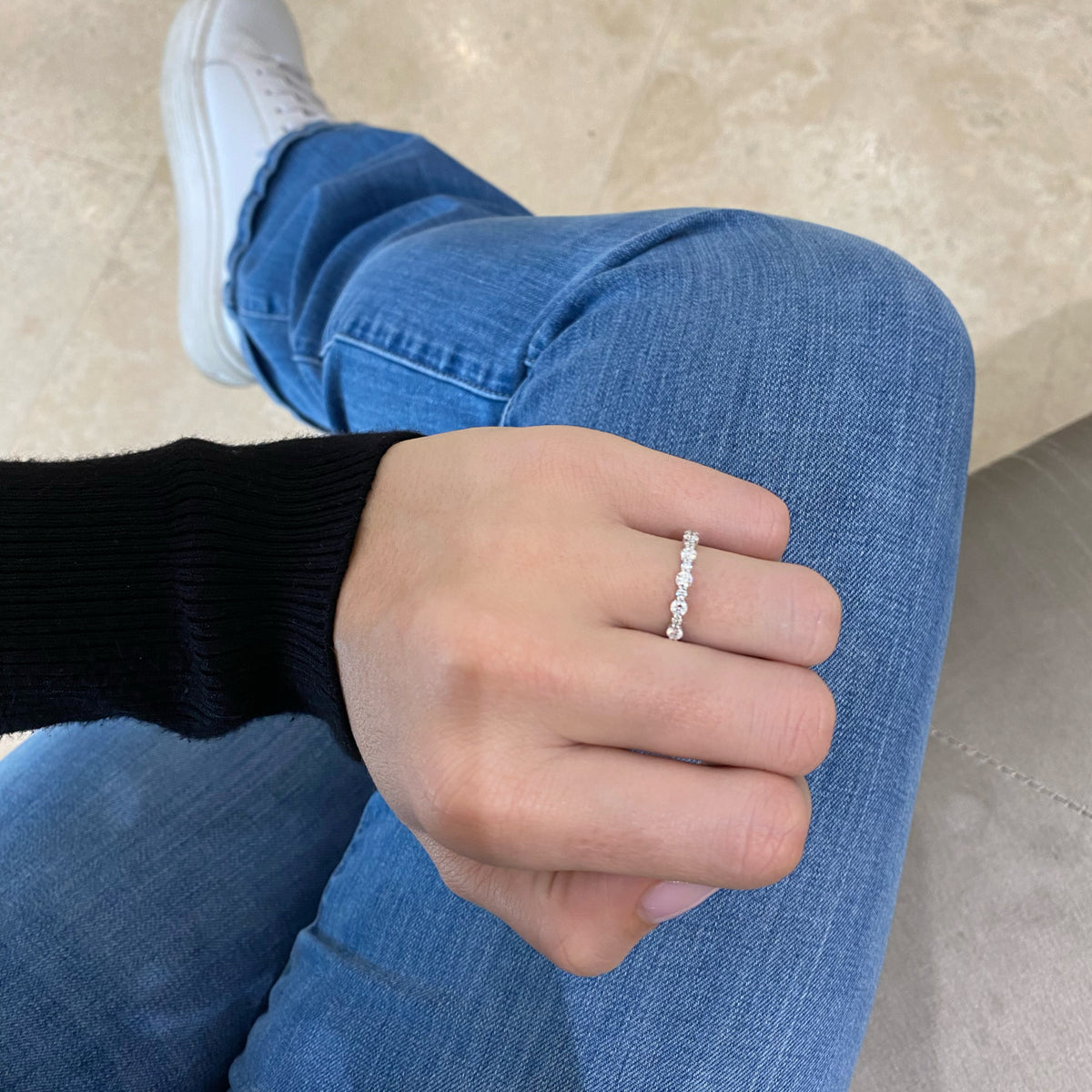 Female model wearing Diamond Pattern Wedding Band - 14K gold weighing 1.44 grams - 8 round diamonds weighing 0.56 carats - 7 round diamonds weighing 0.13 carats