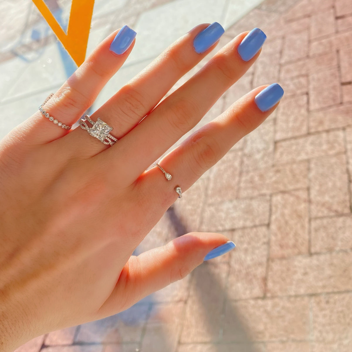 Female Model Wearing Petite Diamond Infinity Ring  -14k gold weighing 1.89 grams  -63 round four prong-set diamonds weighing 0.18 carats 