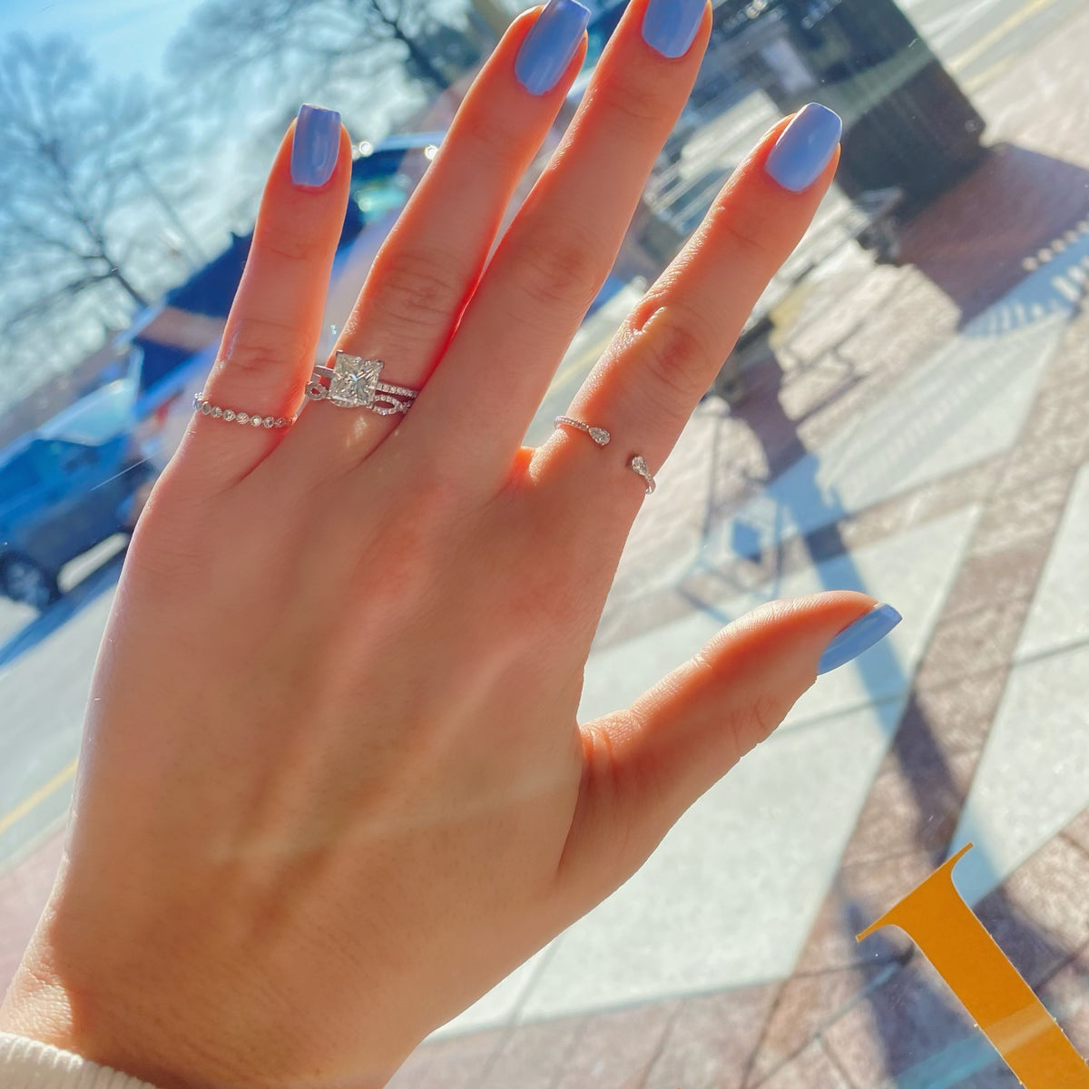 Female Model Wearing Princess-Cut Diamond Engagement Ring with Pave Diamond Shank  -18K weighting 2.31 GR  - 34 round diamonds totaling 0.52 carats