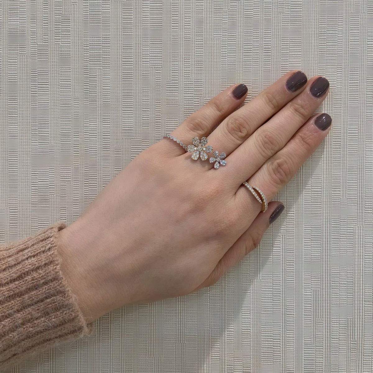 Diamond Flower Double Finger Ring  - 14K gold weighing 3.09 grams  - 57 round diamonds totaling 1.02 carats