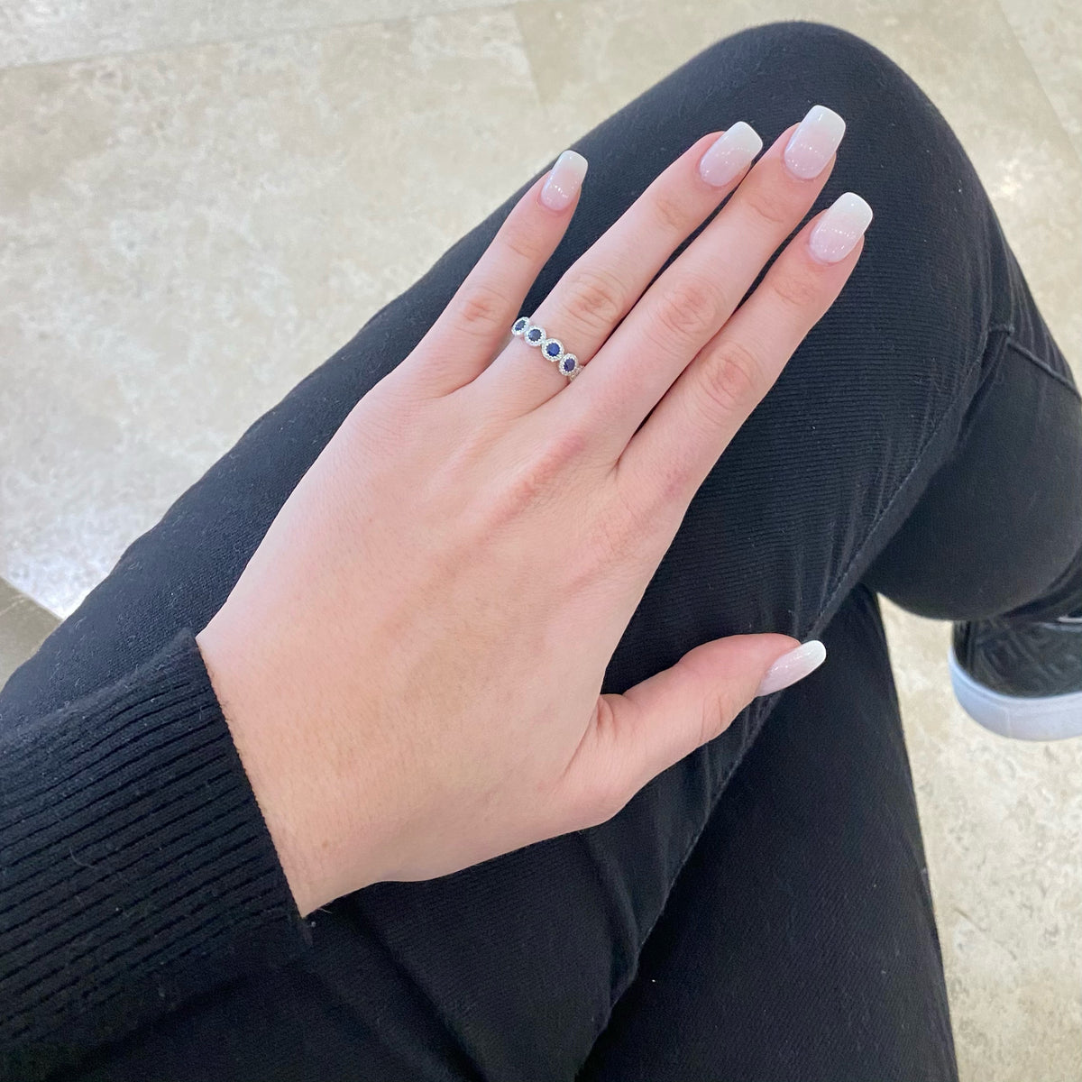 Female Model Wearing Sapphire and Diamond Halo Ring - 14K gold  - 0.20 cts round diamonds  - 0.70 cts sapphires