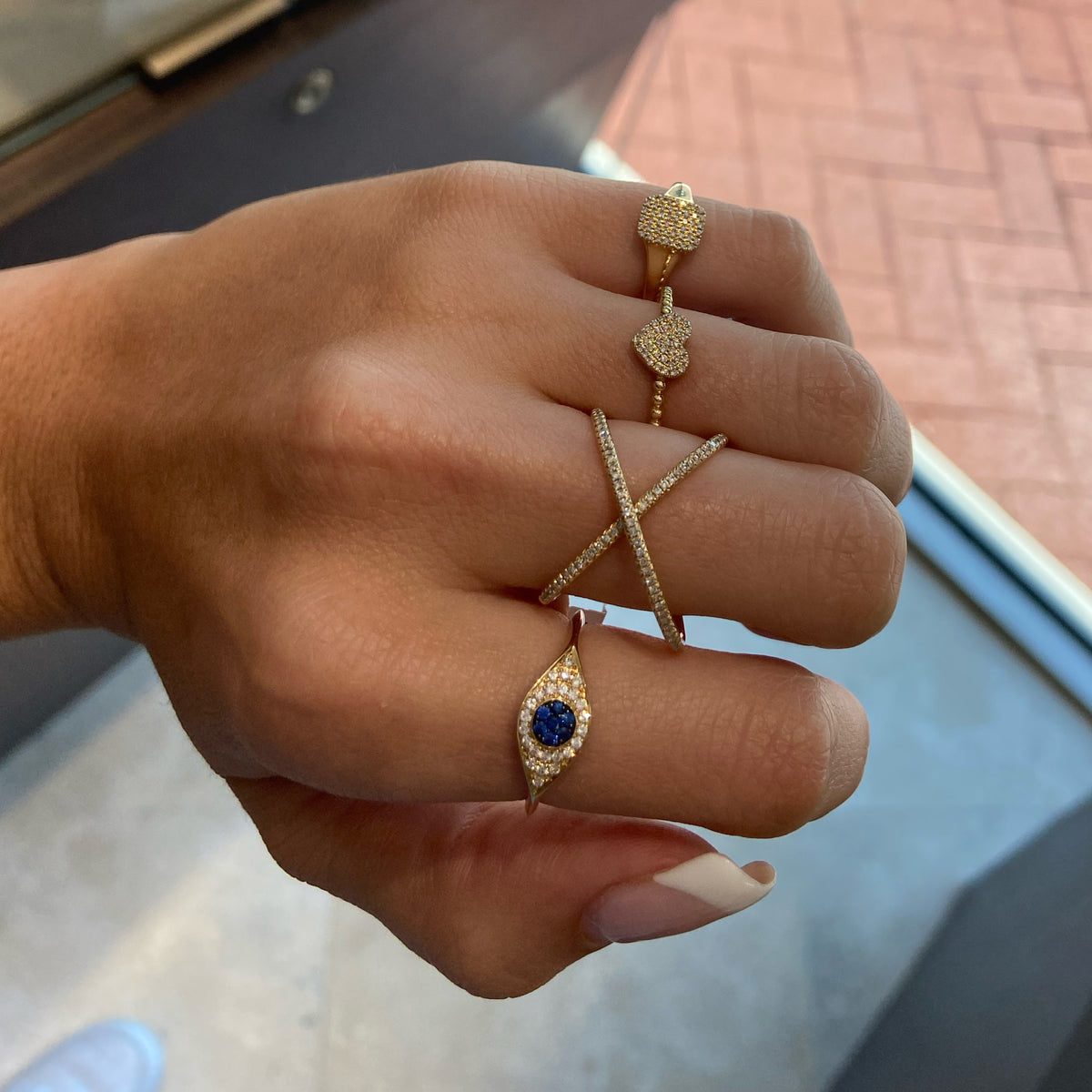 Female model wearing Diamond Signet Pinky Ring  - 14K yellow gold weighing 1.84 grams  - 46 round diamonds totaling 0.12 carats