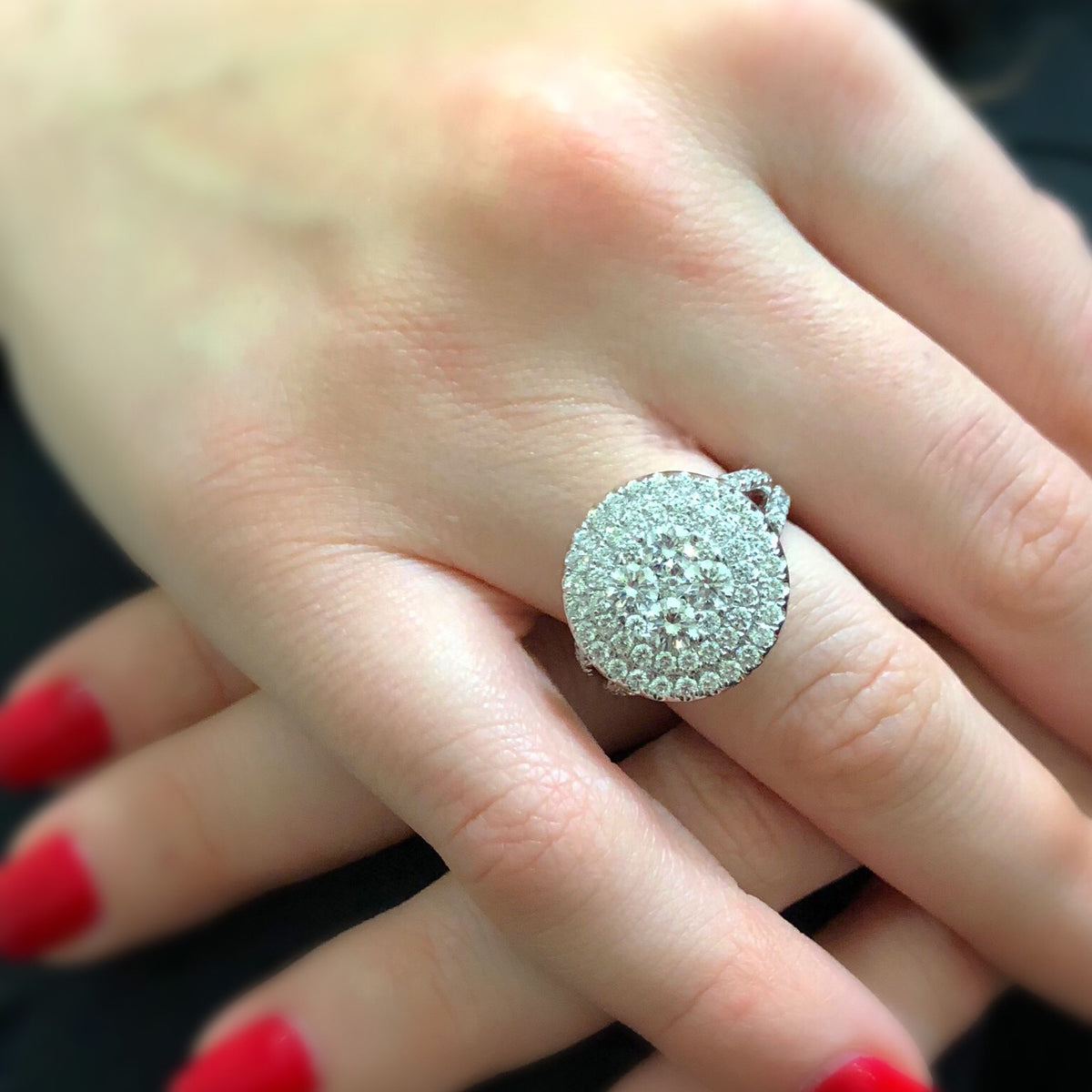 Female Model Wearing Circular Diamond Cluster Engagement Ring  -18k gold weighing 10.51 grams  -79 round diamonds weighing 2.36 carats