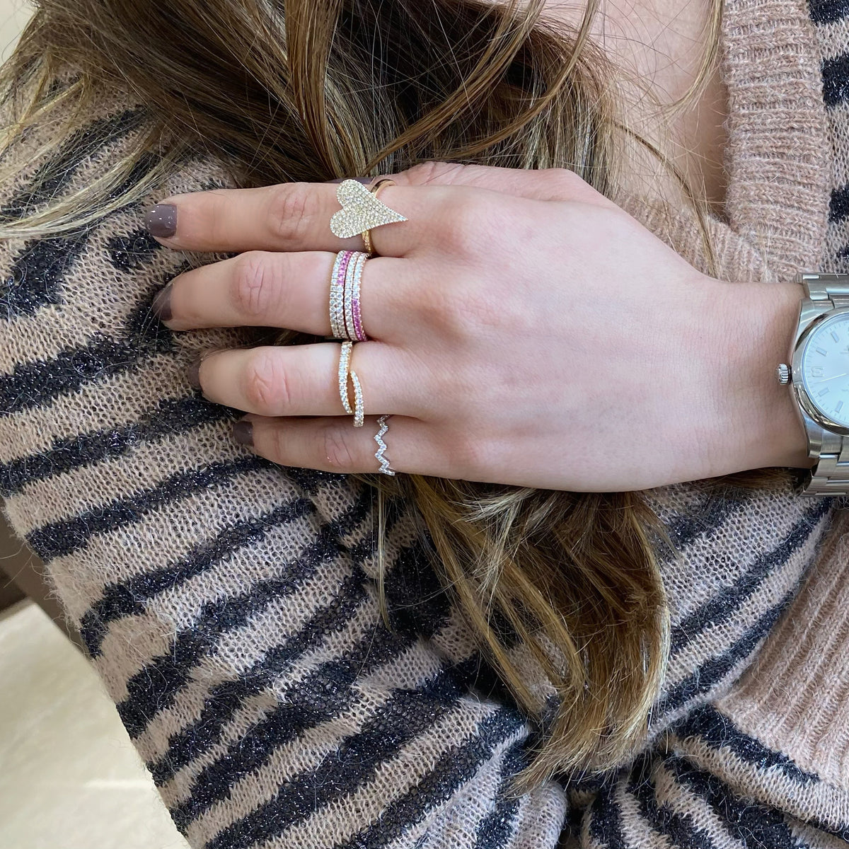 Female model wearing Diamond Zig-zag Pinky Ring- 14K white gold weighing 0.84 grams  - 17 round diamonds totaling 0.13 carats