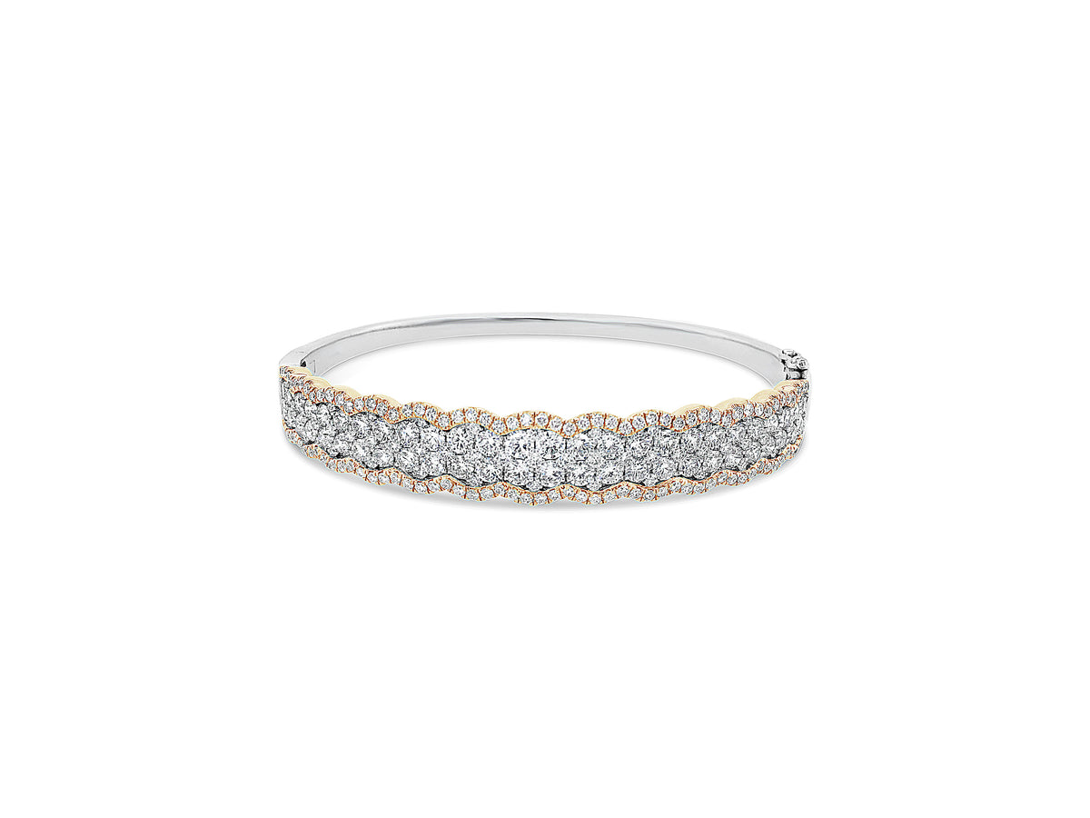 Diamond Two-Tone Bangle Bracelet -18K yellow gold weighing 20.63 grams -52 round diamonds totaling 2.90 carats -157 pave diamonds totaling 1.33 carats