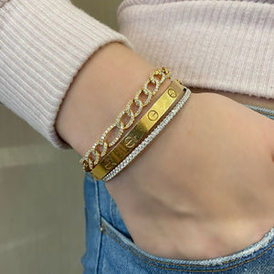 Female model wearing Diamond Figaro Chain Bracelet - 14K gold weighing 13.25 grams - 324 round diamonds totaling 2.67 carats